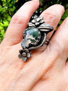 Moss Agate Mushroom sterling silver ring. Handmade with sterling silver sheet and wire sourced in the United States.  Ring design size 1.5 inches long x .7 inches wide. Ring size 7 This is a one of a kind ring with tons of textures and unique botanical motif.  The Moss Agate mushroom cab was sourced specially for me and every tiny detail was handmade, texture and soldered, the ring shank was texture to look like branch trees, it features 2 small flowers , 2 leaf and a textured branch wire around Handmade Silver Moss Agate Rings, Handmade Silver Rings With Moss Agate, Handmade Texture, Mushroom Nature, Branch Tree, Mushroom Ring, Nature Inspired Rings, Moss Agate Ring, Ring Shank