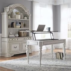 a white piano sitting on top of a wooden floor next to a book shelf and window