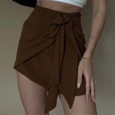 Skirt With Front Tie. Size Small Trendy Brown Mini Skirt, Brown Party Skort For Spring, High-waist Brown Mini Skirt, Casual Summer Party Skirt, Solid Color Mini Skirt For Date Night, Brown Short Length Skort For Summer, Brown Short Skort For Summer, Brown Summer Skort Short Length, Chic Brown Mini Skort