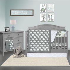 a baby's room with a crib, dresser and stuffed animal in it