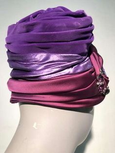 For Sale on 1stdibs - A gorgeous 1950s turban-styled hat in purple velvet, purple satin and burgundy satin with a rhinestone and pearl brooch at front. No maker label present. Purple Fitted Turban For Parties, Fitted Purple Turban For Parties, Elegant Pink Turban For Party, Fitted Purple Party Turban, Purple Evening Headpieces, Elegant Evening Fitted Turban, Elegant Evening Turban, Evening Hat, 1940s Hats