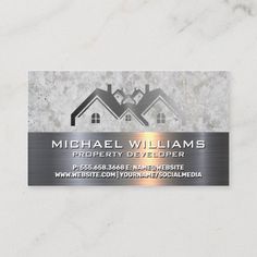 a metal business card with two houses on it