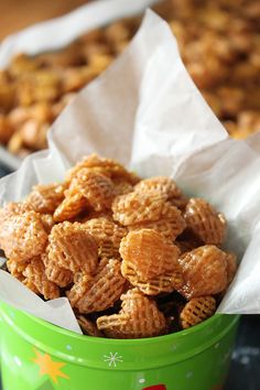 a green bucket filled with cheerios sitting on top of a table