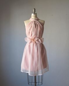 a dress on a mannequin with a bow at the waist