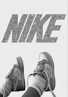 a pair of shoes sitting on top of a white floor next to the words nike