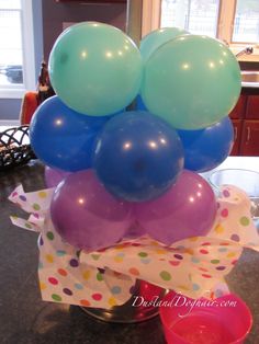 a bunch of balloons sitting on top of a table