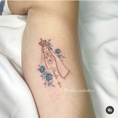 a woman's arm with a tattoo on it that has a drawing of the virgin mary