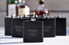 four black flasks sitting on top of a table