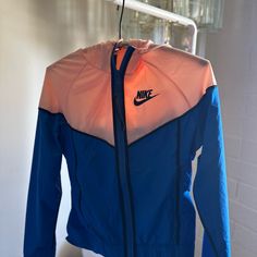 Super Cute Never Been Worn Nike Windrunner! It's Light Peach/Royal Blue And Has A Flap On The Backside With A Mesh Layer As Well. Tags Still Attached! Super Light Weight As Well. It Is An Xs, But I'd Say It Is More Like A Small. Nylon Color Block Activewear Athleisure, Color Block Nylon Sportswear, Nylon Color Block Sportswear Activewear, Color Block Hoodie For Sports In Fall, Fall Sports Hoodie With Color Block, Nike Athleisure Windbreaker For Sports, Fall Sports Color Block Hoodie, Nike Athleisure Track Jacket, Pink Athleisure Hoodie For Outdoor