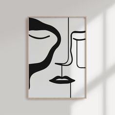 a black and white painting hanging on the wall