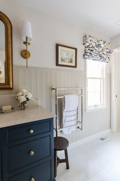 a bathroom with white walls and blue cabinets