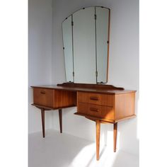 a wooden desk with mirror and two drawers