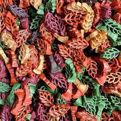 many different colored candies are stacked on top of each other in the shape of leaves