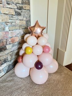 a christmas tree made out of balloons with a star on top