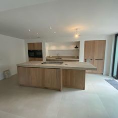 an empty kitchen with wooden cabinets and counter tops