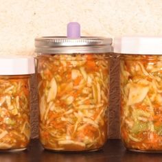 three jars filled with food sitting on top of a table