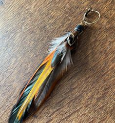 a feather keychain on a wooden table