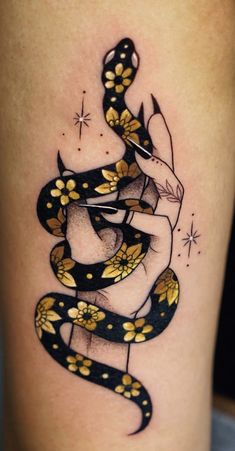 a tattoo design with a snake on the thigh