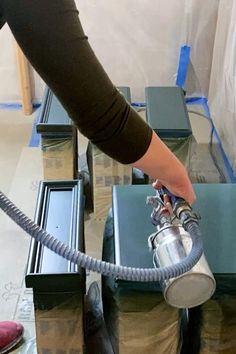 a woman is using a vacuum to clean the floor