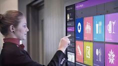 a woman points to the menu on a touch screen