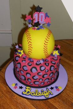 a pink and purple cake with a baseball on top that says 10 in the middle