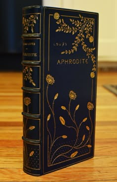 a black book sitting on top of a wooden table