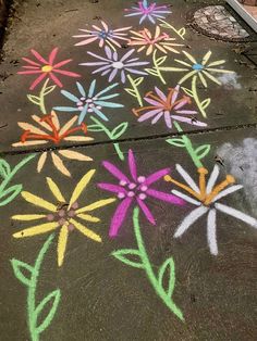 colorful flowers drawn on the sidewalk with chalk