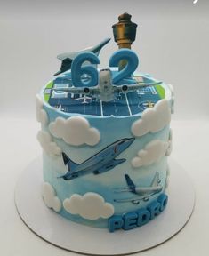 a birthday cake with an airplane theme and the number two on it's side