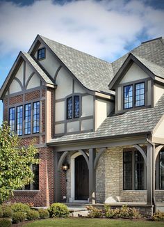 a large brick and stone house with arched windows