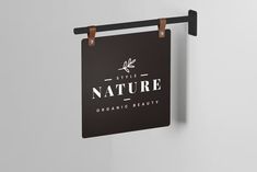 a sign hanging from the side of a wall that says, style nature organic beauty