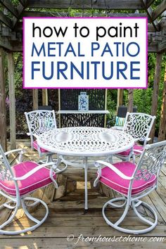 a metal patio furniture set with pink cushions on the back and white chairs around it