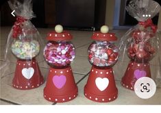 four red candy dispensers with hearts in them