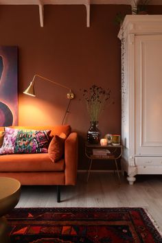 a living room filled with furniture and a painting on the wall