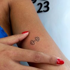 Mini Barbell Tattoo, Dumbbell Tattoo Design For Women, Tattoo Fitness Women, Gym Inspired Tattoos, Gym Rat Tattoo Ideas, Small Gym Tattoos, Gym Tatoos Ideas, Weightlifting Tattoos For Women, Dumbbell Tattoo Design