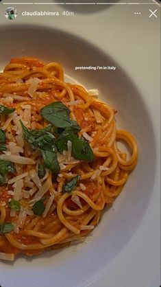 a white plate topped with pasta and sauce