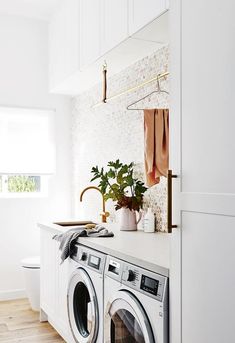 a washer and dryer in a white laundry room