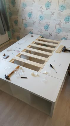 an unfinished bed frame with tools on it