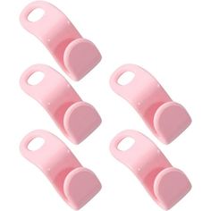 four pink plastic pegs with holes on each side and one hole in the middle