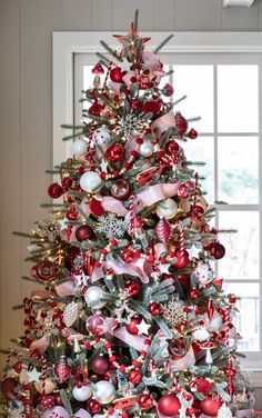 a christmas tree decorated with red and silver ornaments