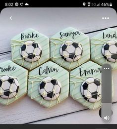 four cookies decorated with soccer balls and names