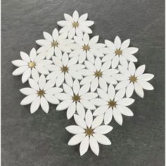 a bunch of white flowers sitting on top of a black table next to each other