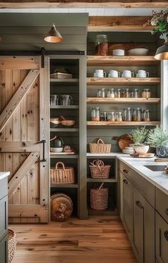 a kitchen with open shelving and wooden floors