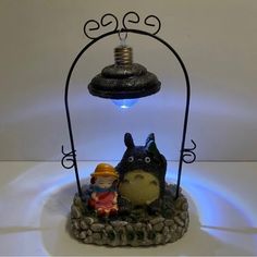 a lamp that is sitting on top of a table next to a figurine