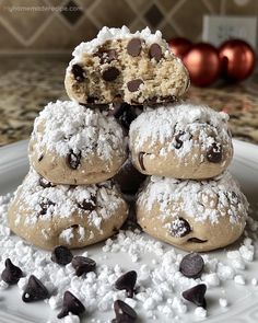 chocolate chip cookies stacked on top of each other with powdered sugar and chocolate chips