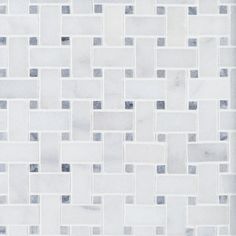 a white and grey tiled wall with squares