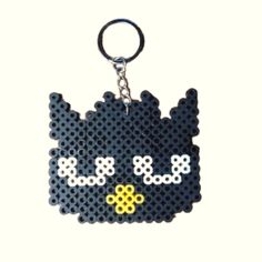 a keychain made out of legos with a cat face on the front