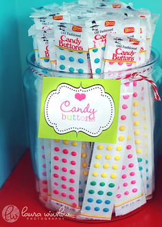 candy buttons in a plastic container with a sign on the top that says candy buttons