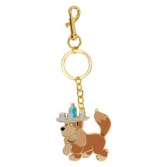 a key chain with a dog wearing a hat