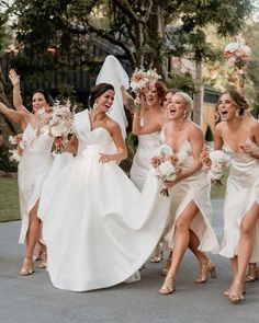 a group of bridesmaids walking down the street