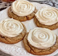 cookies with frosting on a white plate